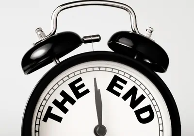 old-fashioned, black and white alarm clock with words "the end"